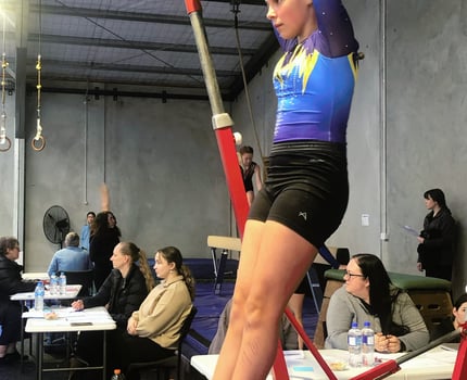 Aiva competing on bar at the 2024 WMGC Competition 